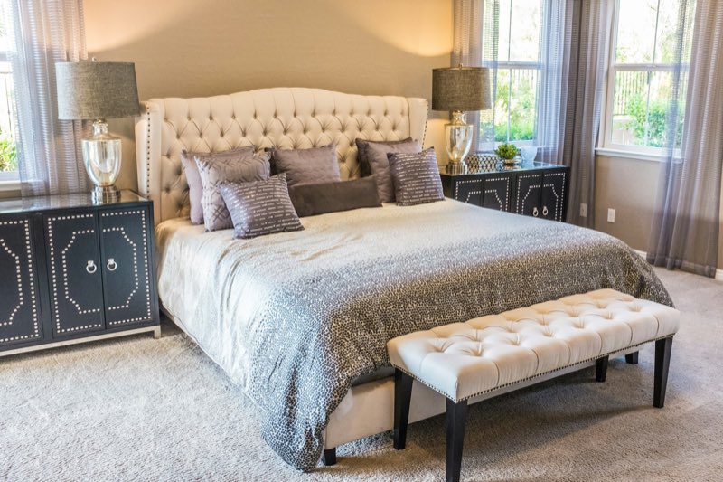 Bedroom in warm tones with layered textiles and soft window light