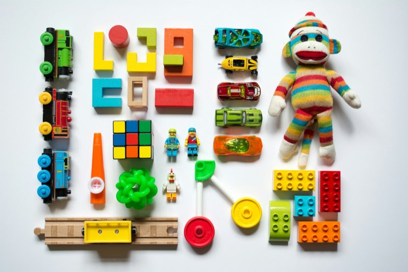 Children's toys arranged in a calm and orderly grid